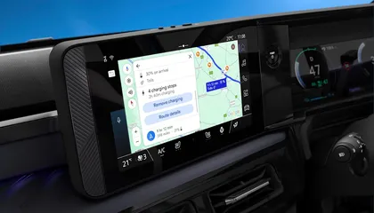 Nissan MICRA dashboard showing navigation on a digital screen with a map and route details, including charging stops and trip duration.