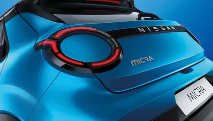 Close-up of a blue Nissan MICRA rear, featuring distinctive round LED taillight design and "MICRA" badge on the hatchback.